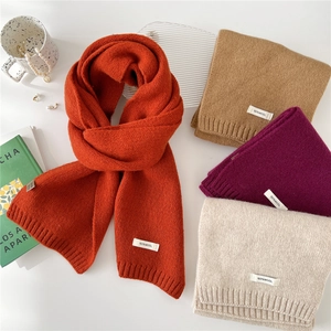 Thick wool knit scarves in multiple colors with 100% wool label for winter warmth
