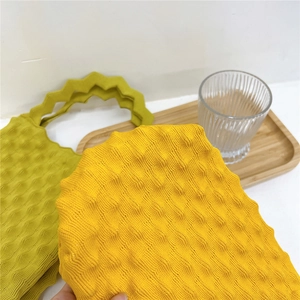 Bubble textured knit tote bag in vibrant yellow and lime green colors with zigzag handles