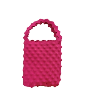 Rose red textured popcorn knit handbag with stylish jagged edges and compact tote design