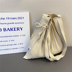 Large cream white pleated knit tote bag with bow detail and vertical accordion folds