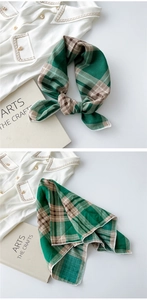 Detail of green and beige plaid cotton linen scarf with elegant stitched edges