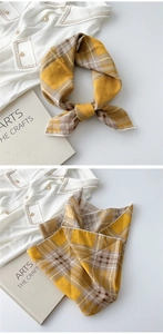 Detailed view of yellow and coffee plaid cotton linen scarf with fine white hemmed edges