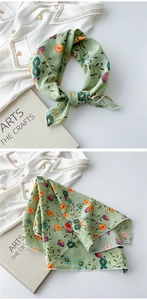 Close-up of green floral cotton linen scarf with delicate white overlock edge details