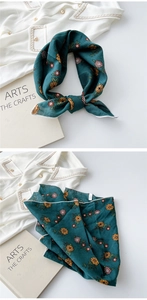 Detailed view of dark green cotton linen scarf featuring vintage floral print and hemmed edges