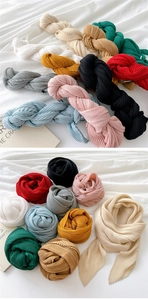 Detailed view of assorted pleated scarves in various colors with textured organza fabric
