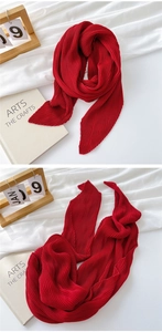 Detail of deep red pleated cotton linen scarf showing vertical pleated fabric texture