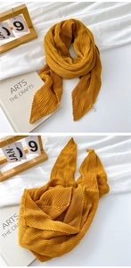 Macro detail of ginger yellow pleated cotton linen scarf with fine accordion folds