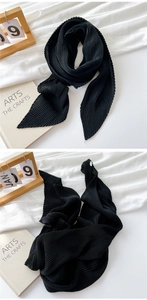 Detailed view of black pleated cotton linen scarf with sharp pointed ends and fine texture