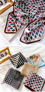 Detailed macro shot of assorted patterned cotton-linen scarves with fine velvet texture