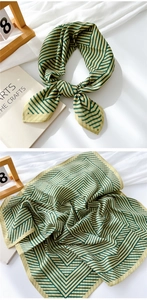Detail of green and beige striped linen cotton scarf showing soft texture and pattern