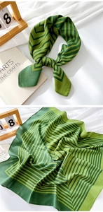 Detail of green cotton linen square scarf with chevron patterns and soft breathable texture