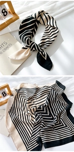 Detail of soft cotton-linen square scarf with elegant black and white geometric patterns