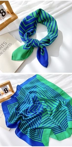 Detail of blue and green geometric stripe cotton linen square scarf draped over books