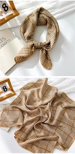 Detail of brown houndstooth cotton linen scarf showing soft texture and elegant drape