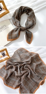 Close-up of houndstooth cotton linen scarf showing classic pattern and brown borders