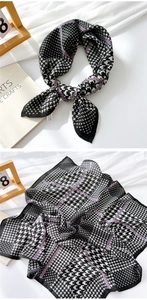 Detail of cotton linen scarf with black houndstooth pattern and modern fashion ribbons
