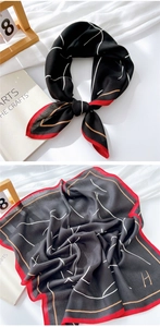 Detail of cotton linen scarf featuring black and red patterns with H letter design