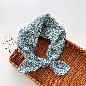 Detailed texture of cotton linen floral scarf with neat stitching in a woven basket