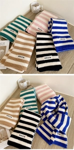 Close-up of thick striped knit scarves with BRICK labels in diverse color combinations