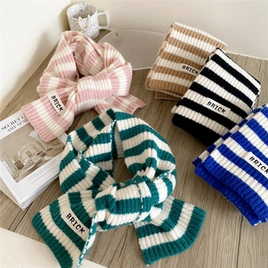 Thick striped knit scarves with BRICK labels in multiple colors for winter warmth