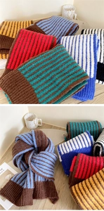 Detailed close-up of thick striped knit scarves showing cozy wool texture and vibrant colors