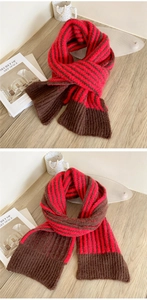 Detailed close-up of thick striped knit scarf with red and brown ribbed texture details