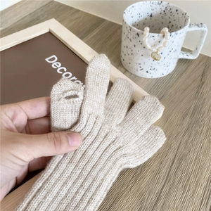 Long beige knit gloves for winter with a fingerless design and touchscreen capability