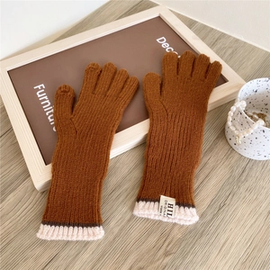 Detail of brown knitted gloves with ribbed texture and two-finger touch screen design
