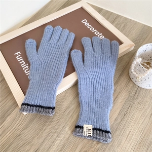 Close-up of light blue ribbed knit touchscreen gloves with HII ORIGINAL label on wood