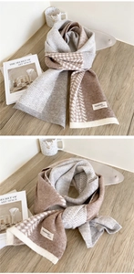 Détail d'une écharpe en maille avec motif pied-de-poule gris-brun et étiquette faite main