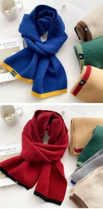 Detailed close-up of colorful knit scarves featuring ribbed ends and luxury brand labels