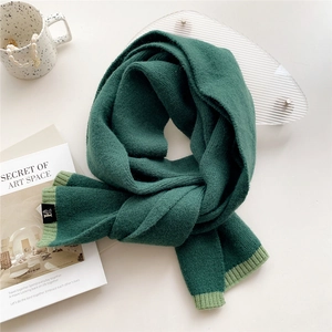 Thick two-tone dark green knit scarf with ribbed light green trim and soft cashmere feel