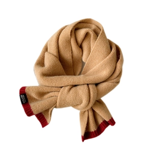 Thick knitted two-tone winter scarf in camel and red with brand label on white background