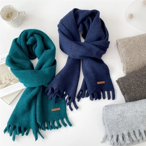 Thick solid knit winter scarf with long tassels and leather label in five assorted colors