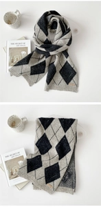 Detail showing grey and black argyle knit scarf texture with a brown leather brand tag