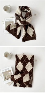 Detail of knitted argyle scarf in brown and beige with high-quality thick texture
