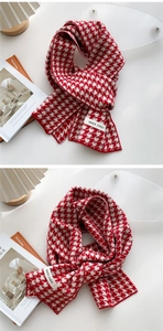 Detailed close-up of knitted houndstooth pattern scarf with a branded woven label