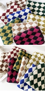 Macro shot of bicolor diamond-pattern knit scarf with soft texture and classic stitching