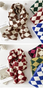 Detail of soft diamond pattern knit scarf in various colors with a stylish winter texture