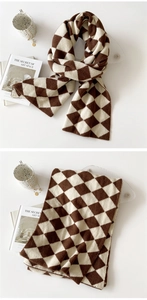 Detail of soft thick knitted diamond lattice scarf in coffee and beige colors
