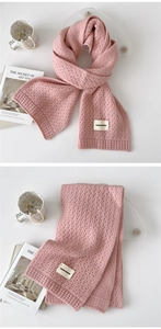 Pink knitted scarf detail showing soft wave texture and DURIAN FREEDOM fabric label