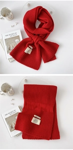 Detailed knit texture of red scarf showing premium PBT blend and vertical stripe pattern