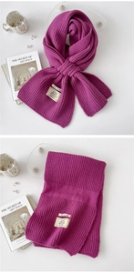 Macro detail of thick purple knit scarf texture and material composition tag