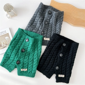 Three colors of chunky knit buttoned neck warmers for women in thick cable knit pattern