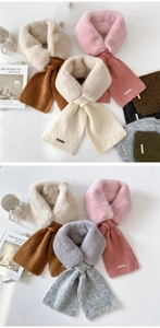 Detail of faux rabbit fur scarf showing plush texture and metallic gold logo badge