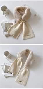 Detail of beige faux fur and knit hybrid scarf with golden metal plate and pull-through design