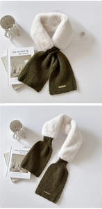 Detail of plush olive green and white patchwork scarf with gold logo on white background