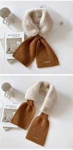 Detail of plush faux fur scarf with caramel knit contrast and metal brand plaque