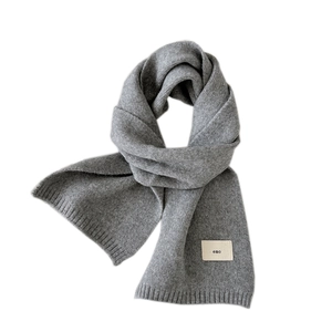 Solid grey knitted scarf with ribbed edges and emo fabric label for winter warmth