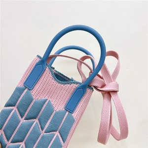 Pink and blue knit mini crossbody phone bag with round handles and woven texture